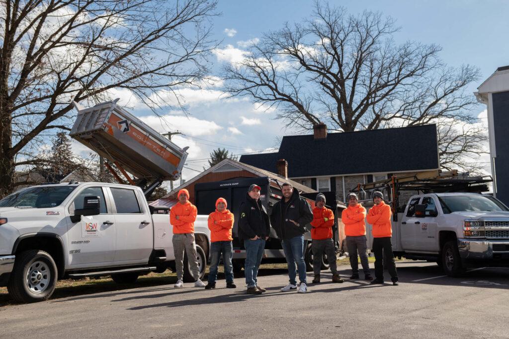 Lancaster's best roofing company stands in front of their work vehicle.