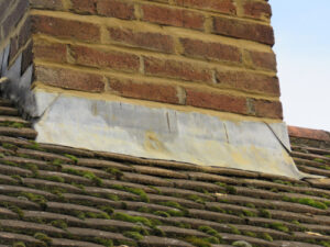 the metal flashing around a chimney is dented and rusted