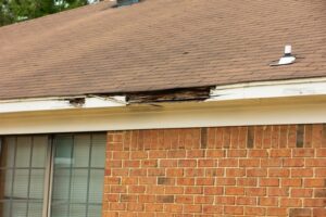 The wooden edges of a roof are rotten and falling apart