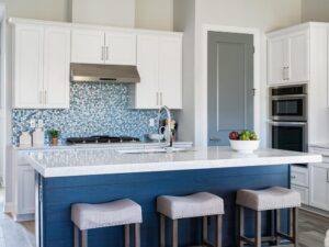 A kitchen with a blue backsplash and island