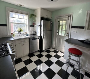 A kitchen with a black and white checkered floor