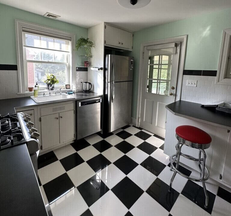 A kitchen remodel with a black and white checkered floor.