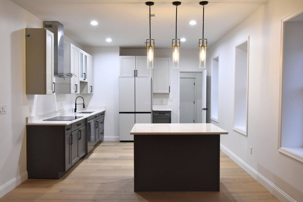 A new kitchen remodel with white cabinets and counters.